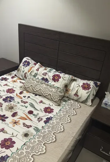 Double-sized wooden bed Includes 2  bedside tables.